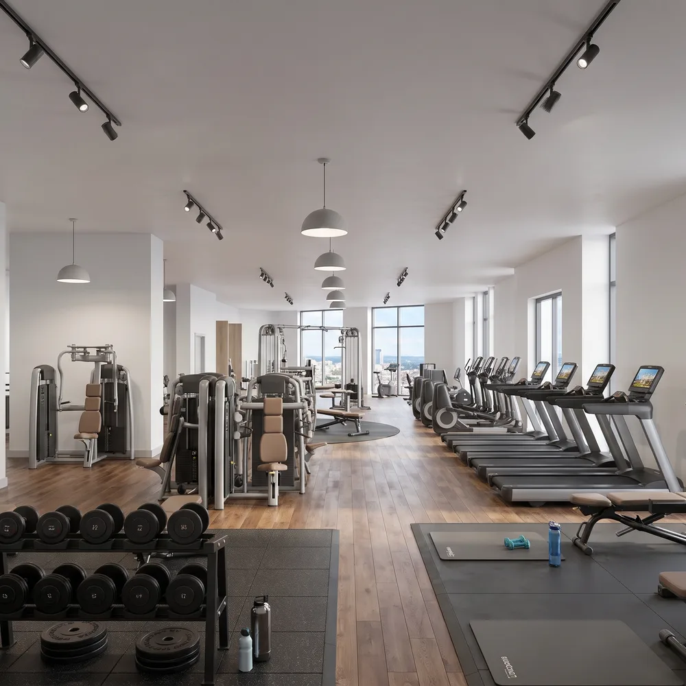 Gym with a timber floor and city views